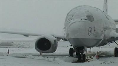 Snow-covered plane at Geneva airport