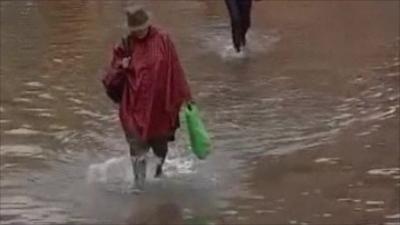 Woman walking in flooded streets