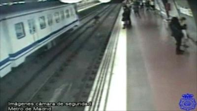 The man is pulled clear of the incoming train