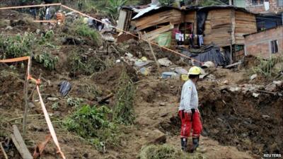 Rescue worker standing by mudslip in Medellin