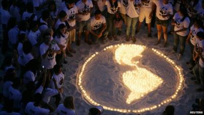 WWF supporters gather around image of the Earth picked out in candles