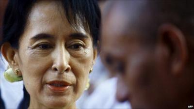 Burma's Aung San Suu Kyi greets a monk in December 2010 soon after her release from house arrest