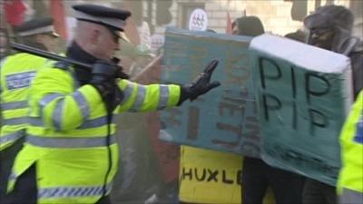 Police officer pushes back protesters