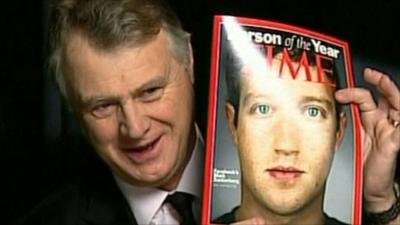 Michael Elliott holds up Time magazine featuring Mark Zuckerberg on cover