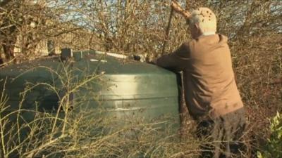 Man checking oil tank