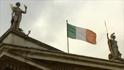 Irish flag between two statues