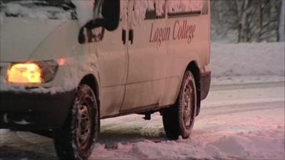 A van drives through snow in Belfast