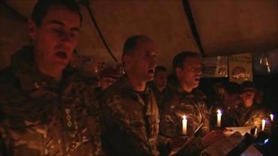 British soldiers singing carols by candlelight in Afghanistan