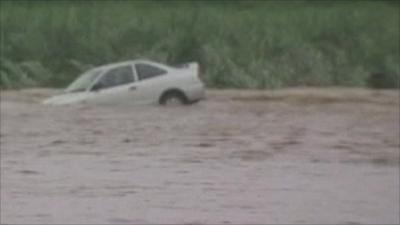 Submerged car in floodwaters