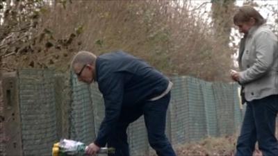 Miss Yeates' parents lay flowers at the scene where her body was found