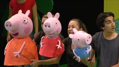 Peppa Pig puppets with puppeteers on stage