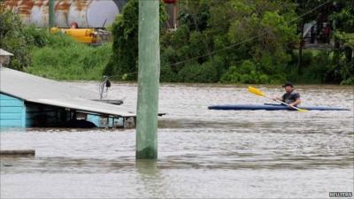 Man in canoe in flooded town