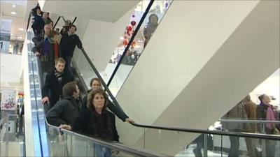 Shoppers on an escalator