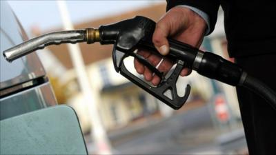 Customer pulls the nozzle of a petrol pump