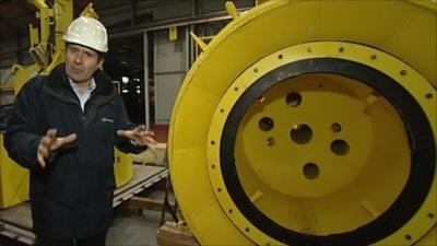 David Shukman next to an upturned 'top hat' oil cap