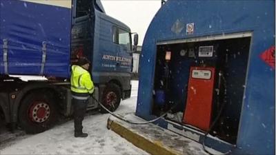 Lorry driver filling up petrol