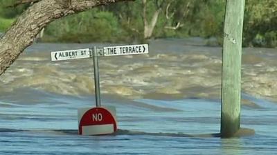 Road sign surrounded by water