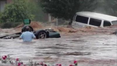 Car and van swept away by floods