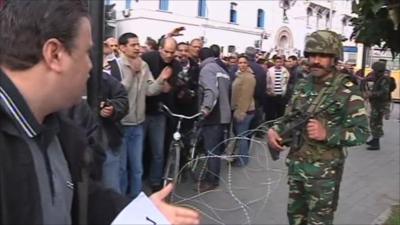 Soldiers keep a watchful eye on the protesters