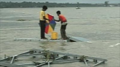 Sri Lankans standing in flood waters