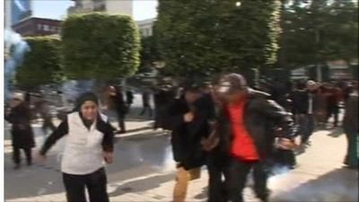 People fleeing tear gas in Tunis