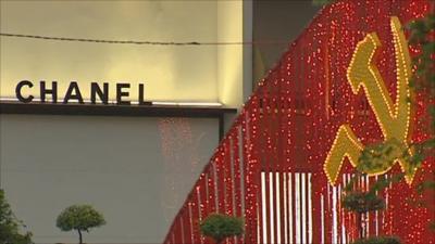 Vietnamese flag in lights next to Chanel sign