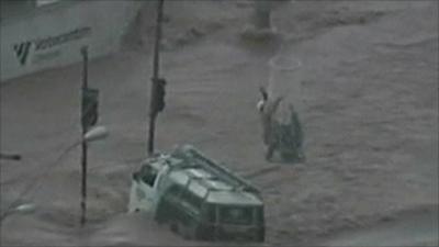 People being rescued from flooded bus