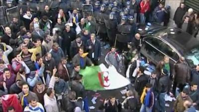 Protesters are confronted by police in Algiers