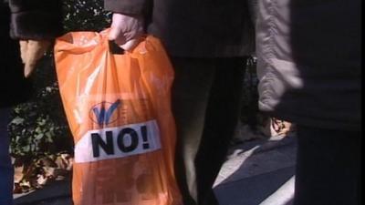 Protesters wait in line