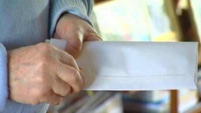 Man opening a letter