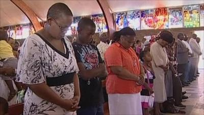 People praying in South Africa