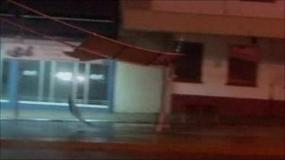 Debris flying down street in Cairns, northeastern Australia