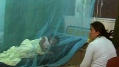 Child with dengue fever in a hospital bed