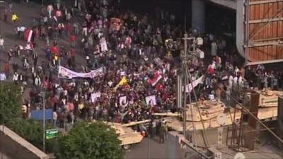 Army tanks create a barrier for Pro-Mubarak supports trying to enter Cairo's Tahrir Square