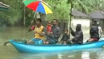 People escaping flooding by boat