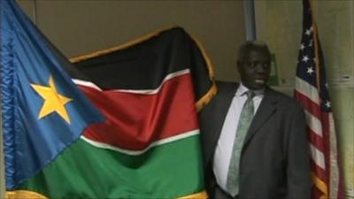 Sudanese man with South Sudan flag and US flag