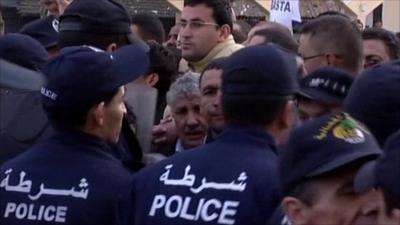 Police and protesters at rally in Algiers