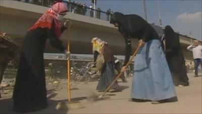 Egyptian women cleaning streets