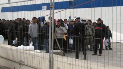 Would-be migrants believed to be from Tunisia are gathered at the port of the Sicilian island of Lampedusa, Italy