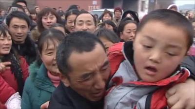 Crowds greeting returned boy