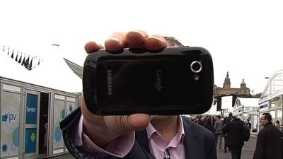 Rory Cellan Jones thrusting a mobile phone into camera lens