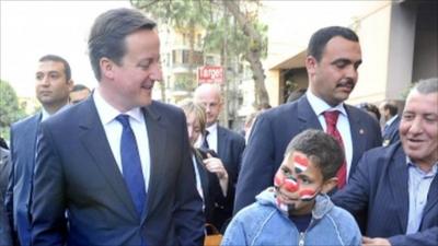 Prime minister David Cameron meets Mohammed, 15, during a walk through the streets around Tahrir Square in Cairo, Egypt.