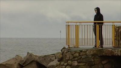 Young man looking across the Atlantic Ocean