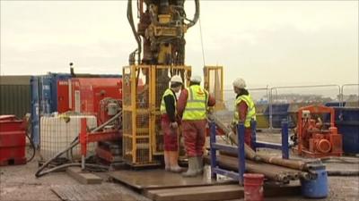 Engineers next to drilling equipment