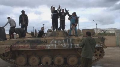 Children playing on an army tanker