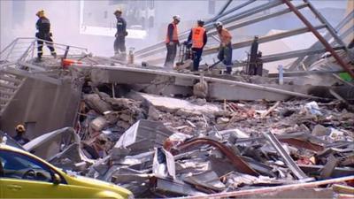 Rescue workers sort through rubble