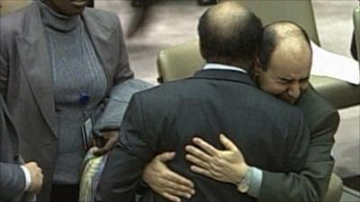 Mohamed Shalgham being embraced by Libya's deputy to the United Nations, Ibrahim Dabbashi