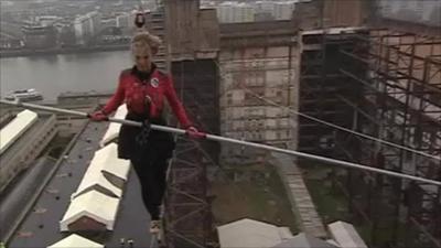 Blue Peter presenter Helen Skelton walking a tightrope between the chimneys of Battersea Power Station