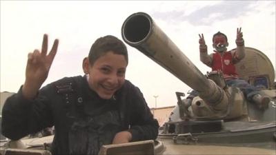 Libyan rebel children with a captured tank