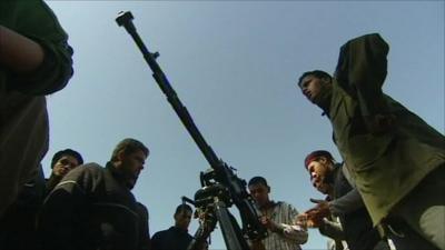 Men gathered around a weapon